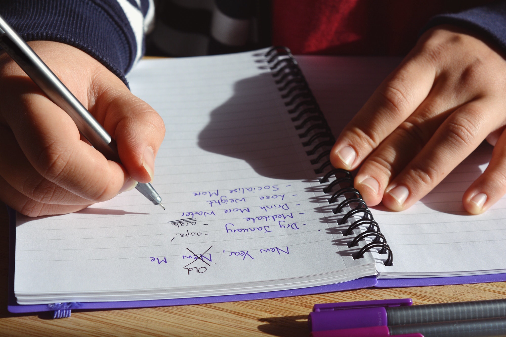Millennial woman updating list of failed New Year Resolutions, New Year, New Me