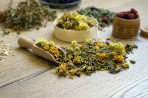 Dry organic ecological herbal tea, berries in a wooden dishes. Antistress, relaxation wellbeing